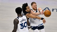 Dallas Mavericks guard Ryan Nembhard (9) knocks the ball away from Minnesota Timberwolves guard Donte DiVincenzo (0) during the first quarter at the American Airlines Center.