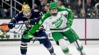 Michigan State's Ryker Lee, right, moves the puck against Notre Dame's Pano Fimis during the third period on Thursday, Feb. 19, 2026, at the Munn Ice Arena in East Lansing.