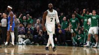 Celtics guard Jaylen Brown smiles after being fouled while making a shot by Oklahoma City Thunder guard Shai Gilgeous-Alexander (2) (left) during the fourth quarter at TD Garden