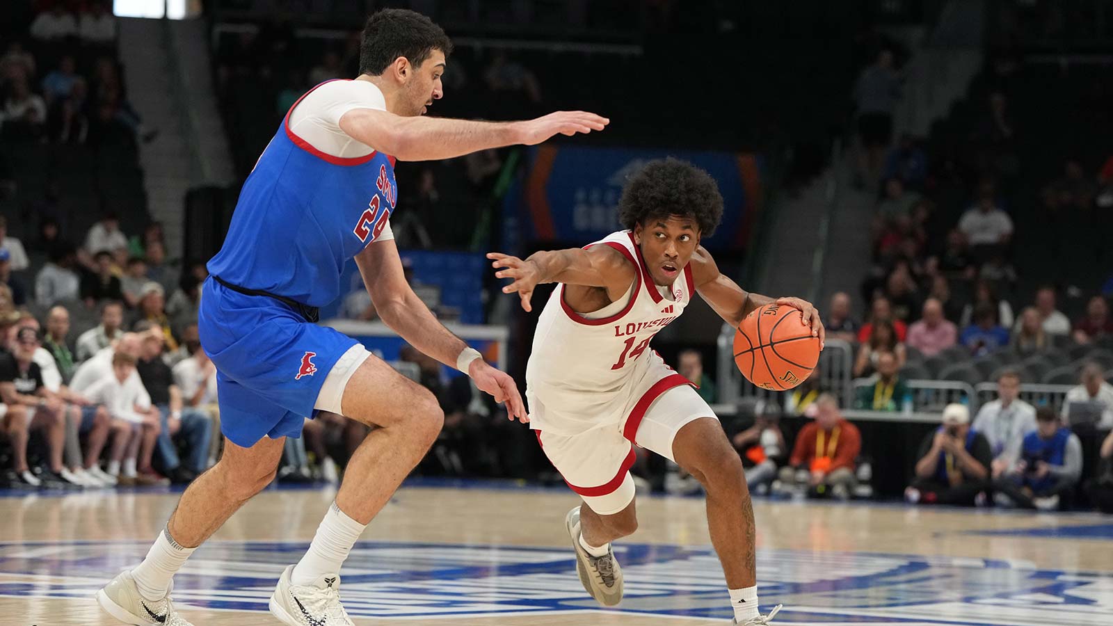 Louisville Cardinals guard Adrian Wooley (14) with the ball as Southern Methodist University Mustangs center Samet Yigitoglu (24) defends in the second half at Spectrum Center.