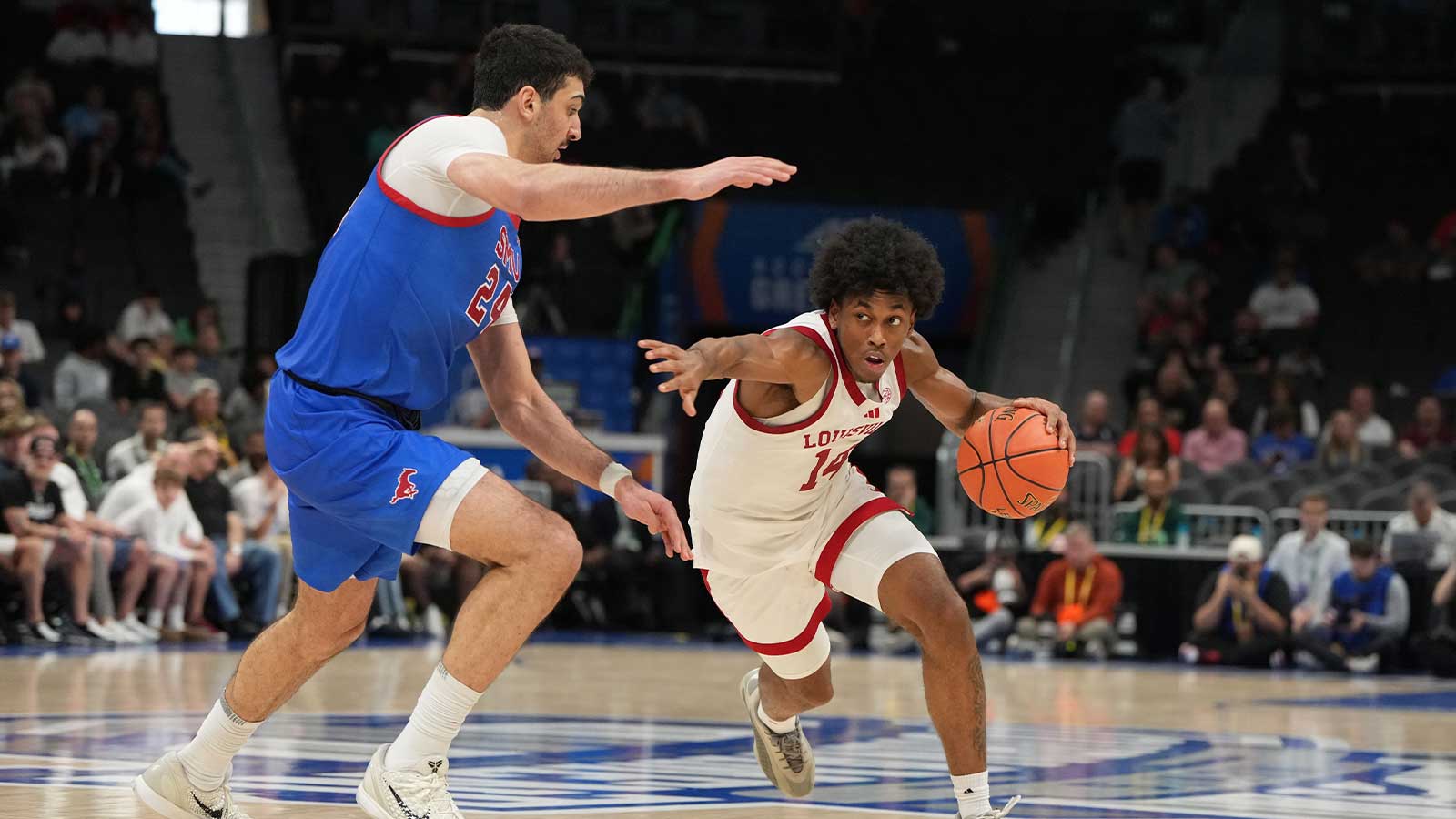 Louisville Cardinals guard Adrian Wooley (14) with the ball as Southern Methodist University Mustangs center Samet Yigitoglu (24) defends in the second half at Spectrum Center.