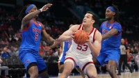 Louisville Cardinals forward Vangelis Zougris (53) with the ball as Southern Methodist University Mustangs guard Jaron Pierre Jr. (5) and center Jaden Toombs (10) defend in the second half at Spectrum Center. Mandatory Credit: Bob Donnan-Imagn Images