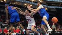 Louisville Cardinals forward Vangelis Zougris (53) is fouled by Southern Methodist University Mustangs guard Jaron Pierre Jr. (5) and center Samet Yigitoglu (24) in the second half at Spectrum Center.