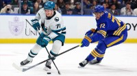 Buffalo Sabres center Tage Thompson (72) knocks the puck away from San Jose Sharks center Macklin Celebrini (71) during the first period at KeyBank Center.