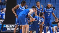 Saint Louis Billikens forward Ishan Sharma (9) is helped to his feet by center Robbie Avila (21) and guard Trey Green (3) after getting fouled by Georgia Bulldogs guard Blue Cain (not pictured) during the second half of a first round game of the men's 2026 NCAA Tournament at Keybank Center.