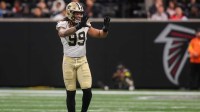 New Orleans Saints defensive end Chase Young (99) celebrates after a sack against the Atlanta Falcons in the fourth quarter at Mercedes-Benz Stadium.