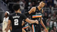 San Antonio Spurs forward Victor Wembanyama (1) and guard Dylan Harper (2) shake hands during the fourth quarter against the Milwaukee Bucks at Fiserv Forum.