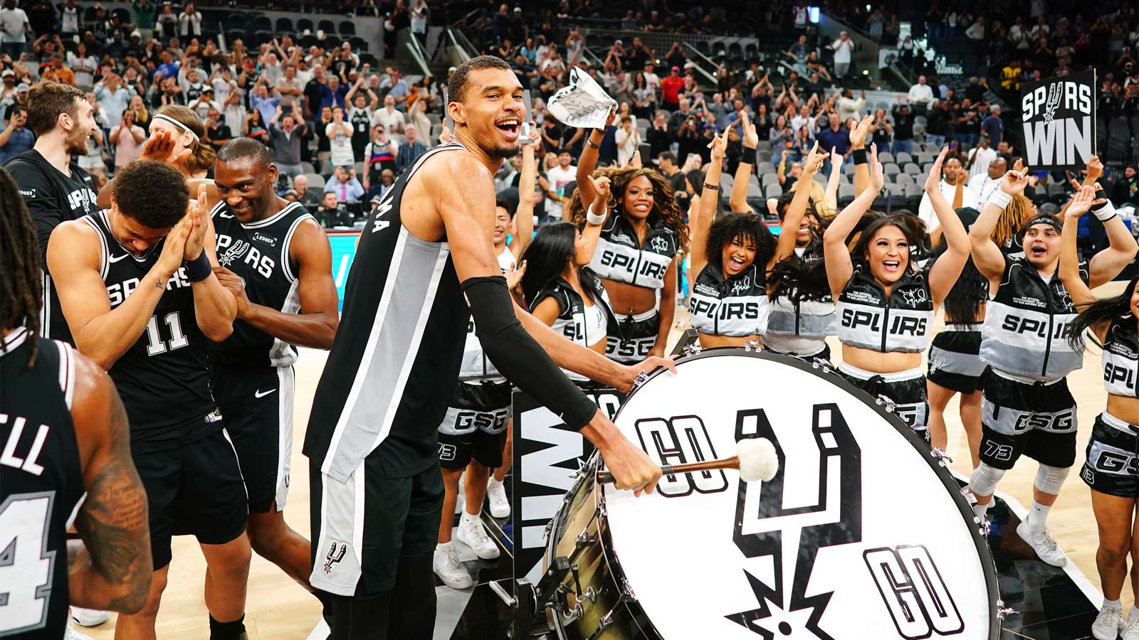 San Antonio Spurs forward forward Victor Wembanyama (1) beats a drum and leads fans on a cheer after a victory over the Detroit Pistons
