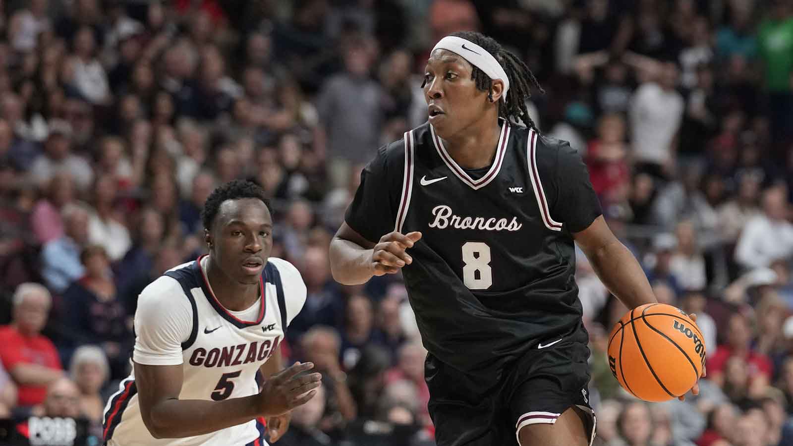 Santa Clara Broncos forward Elijah Mahi (8) dribbles the basketball against Gonzaga Bulldogs forward Emmanuel Innocenti (5) during the second half at Orleans Arena.