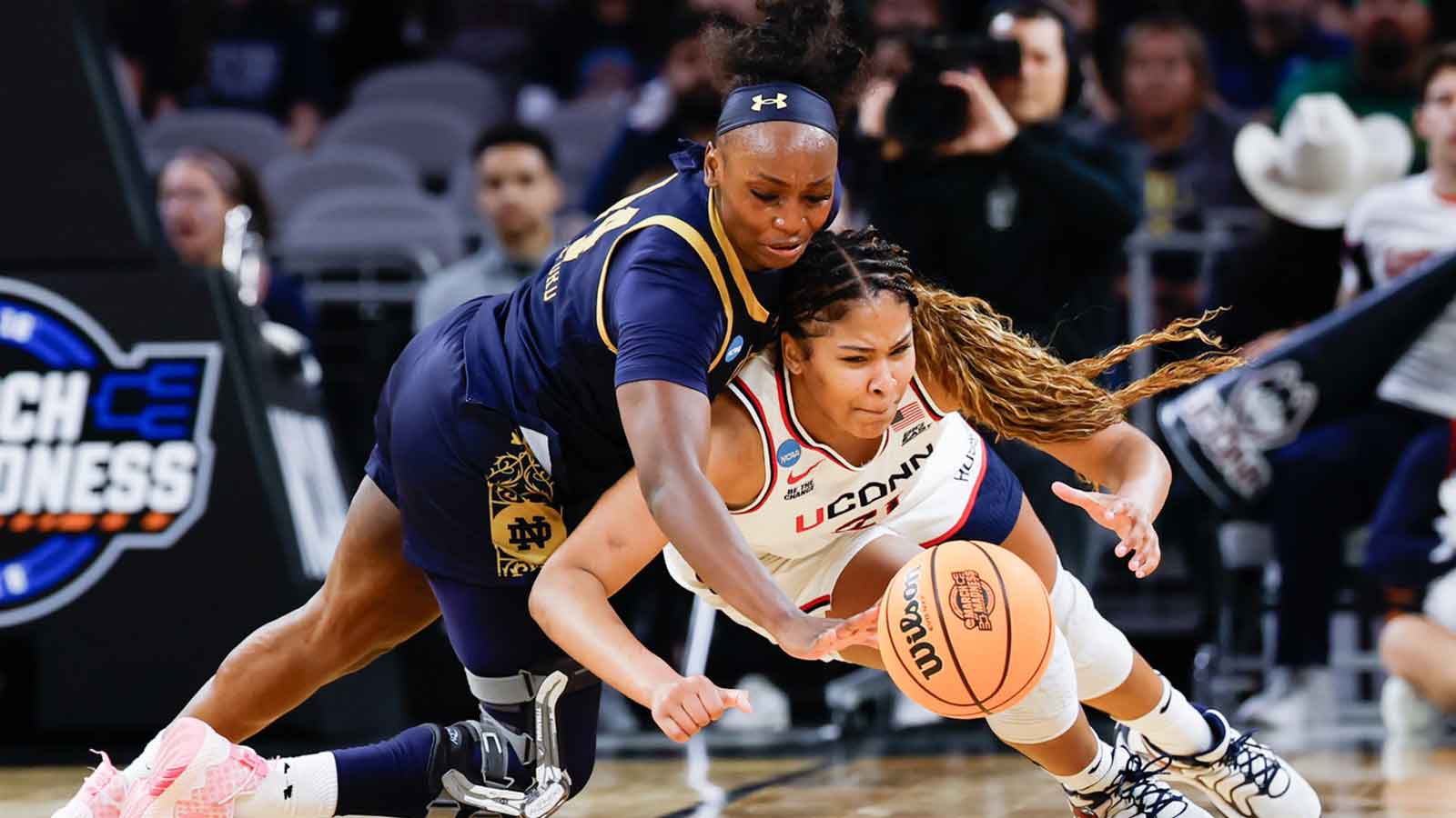 Notre Dame Fighting Irish guard Kk Bransford (14) and UConn Huskies forward Sarah Strong (21) chase the ball during the second half at Dickies Arena.