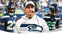Seahawks WR Rashid Shaheed and CB Josh Jobe. Head coach Mike Macdonald in the middle Seahawks logo in front