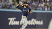 Seattle Mariners shortstop J.P. Crawford (3) attempts to throw to first against Toronto Blue Jays second baseman Andres Gimenez (0) in the second inning during game seven of the ALCS round for the 2025 MLB playoffs at Rogers Centre.