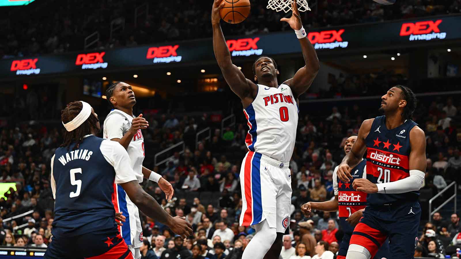 Detroit Pistons center Jalen Duren (0) grabs a rebound over Washington Wizards guard Jamir Watkins (5) and center Alex Sarr (20) during the first half at Capital One Arena.