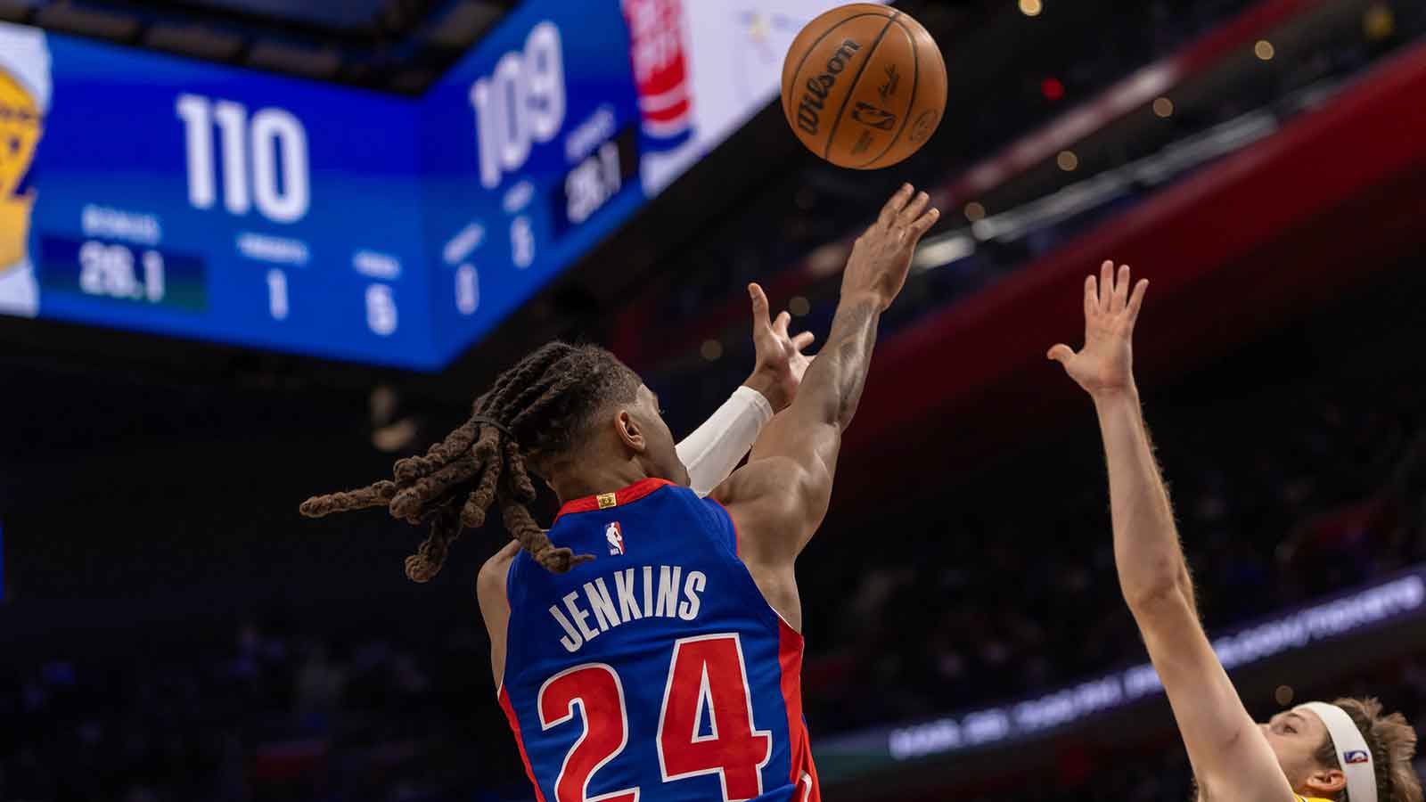 Detroit Pistons Daniss Jenkins (24) shoots a big two point basket late in fourth quarter as Los Angeles Lakers Austin Reaves (15) defends at Little Caesars Arena.