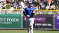 Chicago Cubs right fielder Seiya Suzuki (27) runs into the dugout against the San Francisco Giants in the third inning at Scottsdale Stadium.