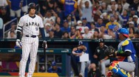 Japan designated hitter Shohei Ohtani (16) reacts toward Venezuela catcher Salvador Perez (13) in the seventh inning during a quarterfinal game of the 2026 World Baseball Classic at loanDepot Park.