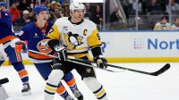 Pittsburgh Penguins center Sidney Crosby (87) skates against New York Islanders defenseman Matthew Schaefer (48) during the first period at UBS Arena