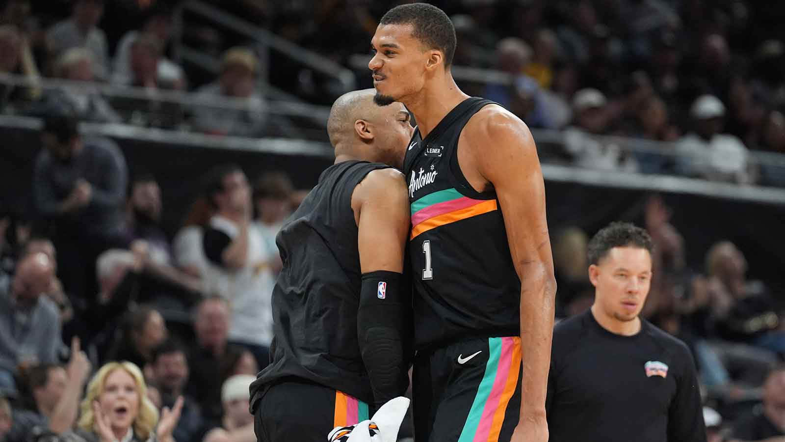 Spurs forwards Keldon Johnson (3) and forward Victor Wembanyama (1) celebrate in the second half against the Sacramento Kings at Moody Center