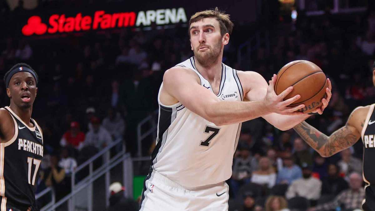 Spurs center Luke Kornet (7) grabs a loose ball against the Atlanta Hawks in the first quarter at State Farm Arena