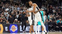 Spurs forward Victor Wembanyama (1) hugs guard Stephon Castle (5) after the game against the Charlotte Hornets at Frost Bank Center