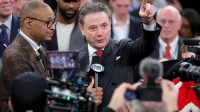 Fox Sports broadcaster Gus Johnson interviews St. John's Red Storm head coach Rick Pitino after St. John's defeats the Connecticut Huskies in the men's Big East Conference Tournament Championship game at Madison Square Garden.