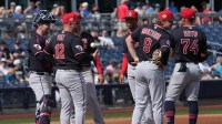 Cleveland Guardians manager Stephen Vogt (12) visits the mound against the Seattle Mariners in the first inning at Peoria Sports Complex.