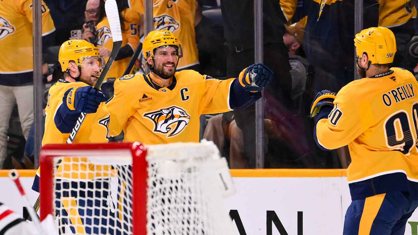 Nashville Predators center Ryan O'Reilly (90) celebrates his goal with center Steven Stamkos (91) and defenseman Roman Josi (59) against the Chicago Blackhawks during the third period at Bridgestone Arena. 