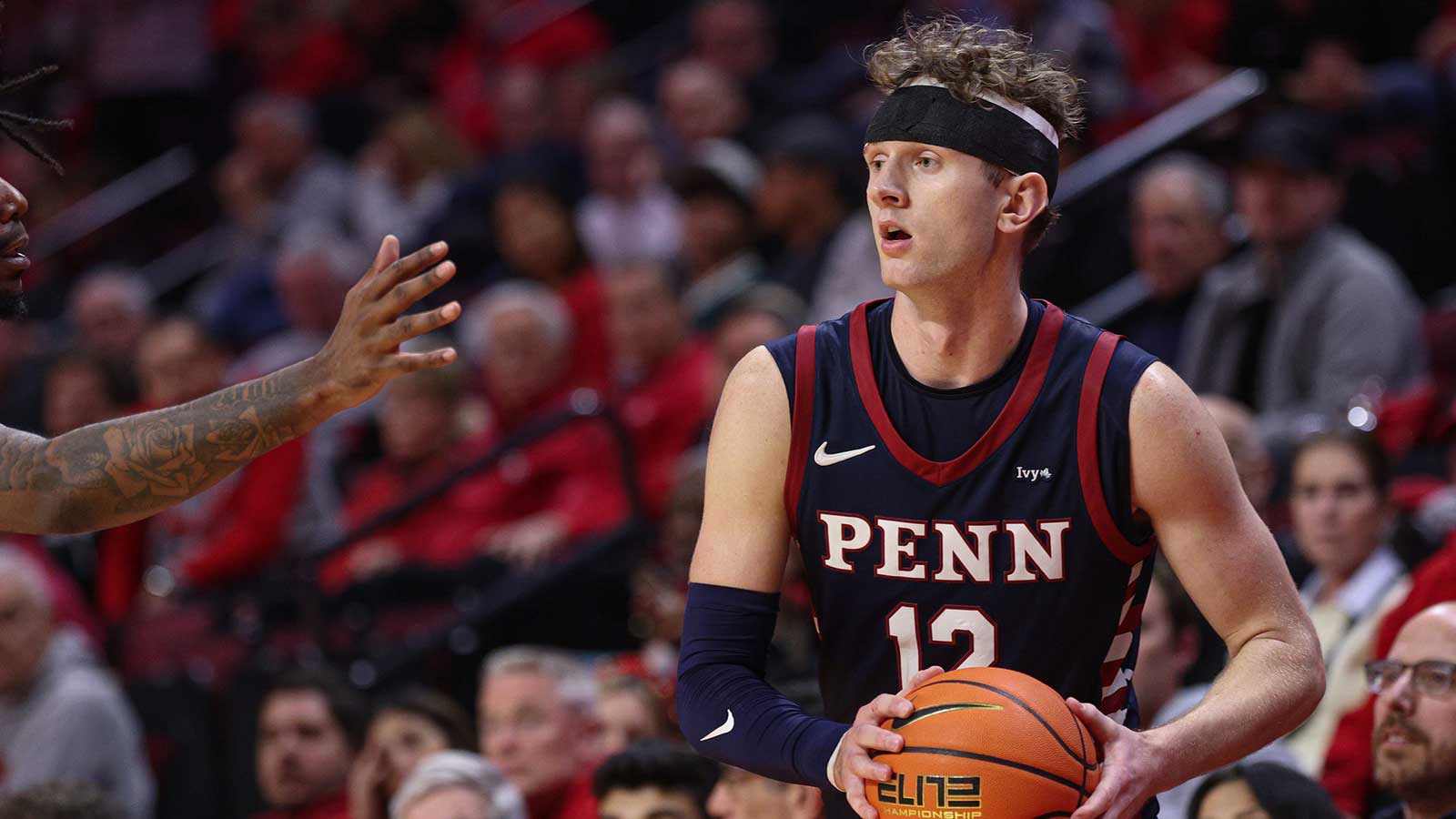 Penn Quakers forward TJ Power (12) looks to pass during the second half against the Rutgers Scarlet Knights at Jersey Mike's Arena.
