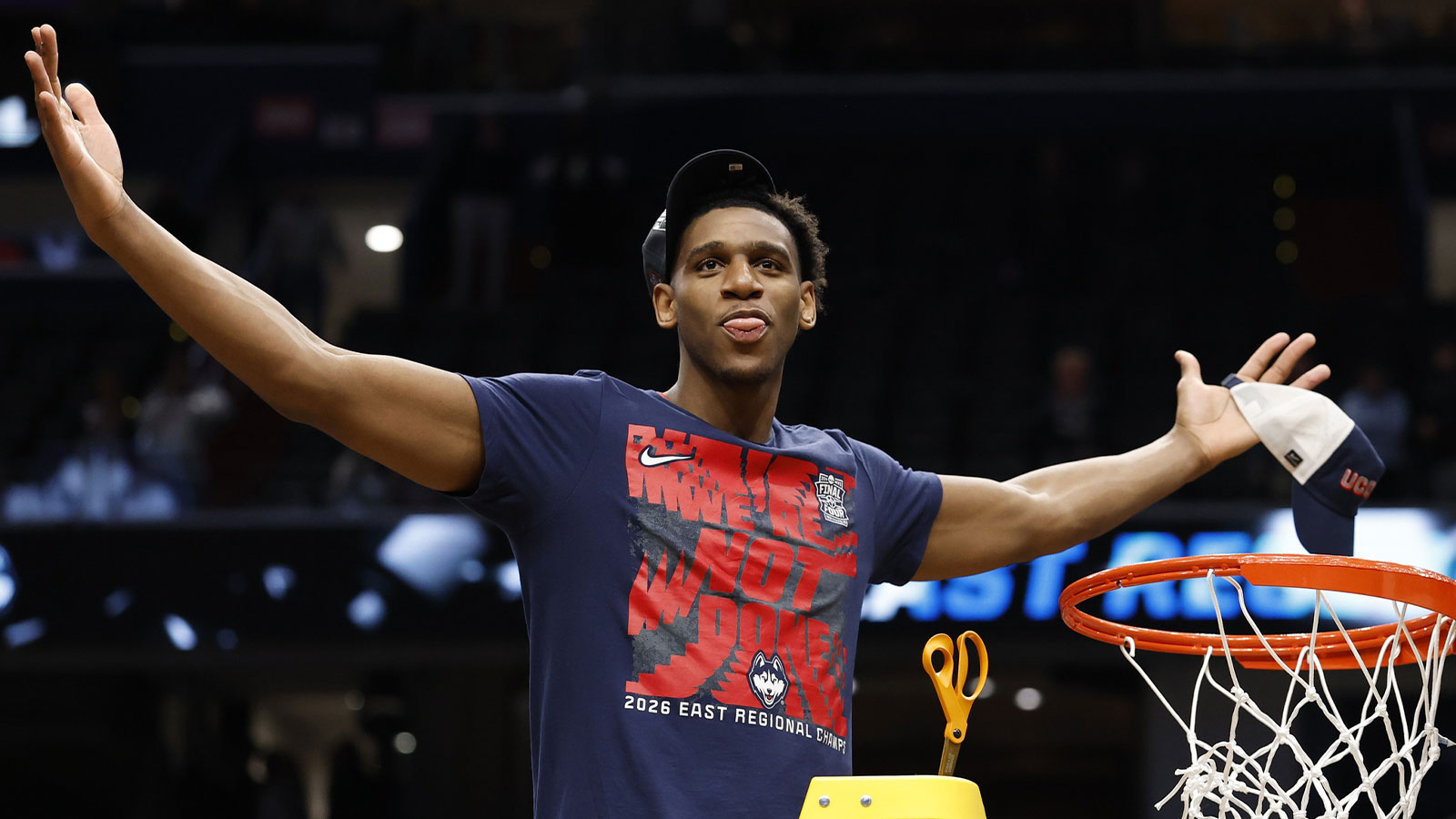 UConn Huskies forward Tarris Reed Jr. (5) cuts down the net after defeating the Duke Blue Devils in an Elite Eight game of the East Regional of the men's 2026 NCAA Tournament at Capital One Arena. 