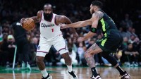 LA Clippers guard James Harden (1) moves the ball against Boston Celtics forward Jayson Tatum (0) in the second half at TD Garden.