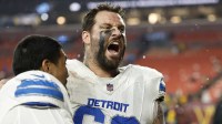 Detroit Lions offensive tackle Penei Sewell (L) celebrates with Lions offensive tackle Taylor Decker (68) while leaving the field after their game against the Washington Commanders at Northwest Stadium.