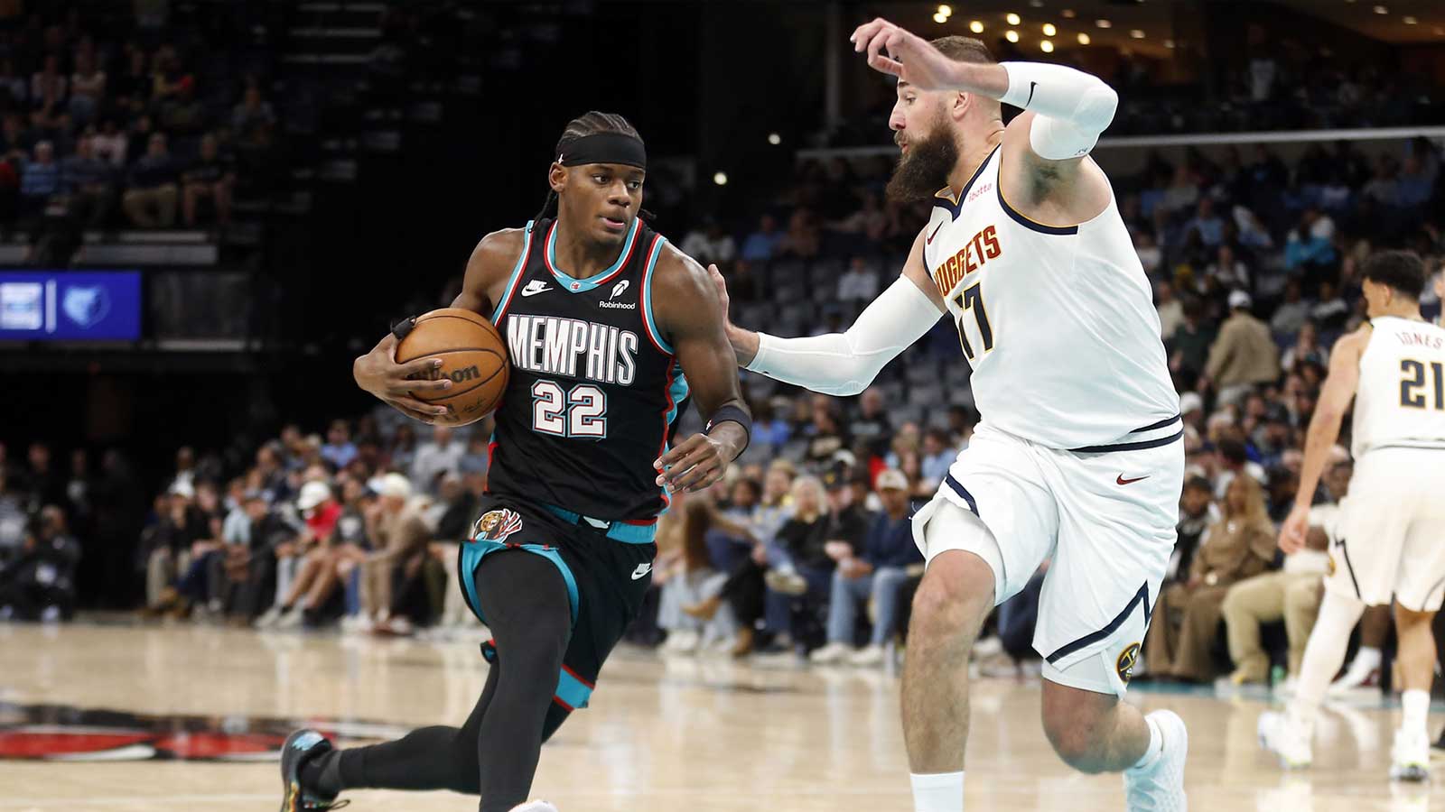 Memphis Grizzlies forward Taylor Hendricks (22) drives to the basket as Denver Nuggets center Jonas Valanciunas (17) defends during the second quarter at FedExForum.