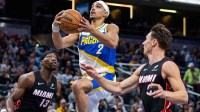 Indiana Pacers guard Andrew Nembhard (2) shoots the ball while Miami Heat guard Pelle Larsson (9) defends in the first half at Gainbridge Fieldhouse.