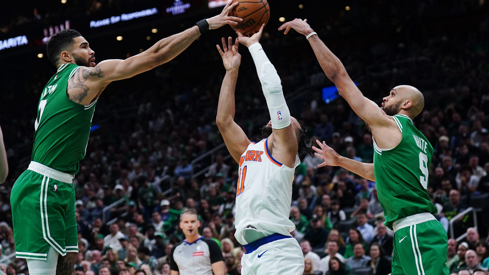 Boston Celtics forward Jayson Tatum (0) and guard Derrick White (9) defend against New York Knicks guard Jalen Brunson (11) in the second quarter during game two of the second round for the 2025 NBA Playoffs at TD Garden.
