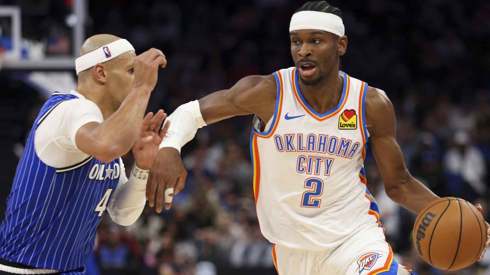 Thunder guard Shai Gilgeous-Alexander (2) drives to the basket past Orlando Magic guard Jalen Suggs (4) in the third quarter at Kia Center