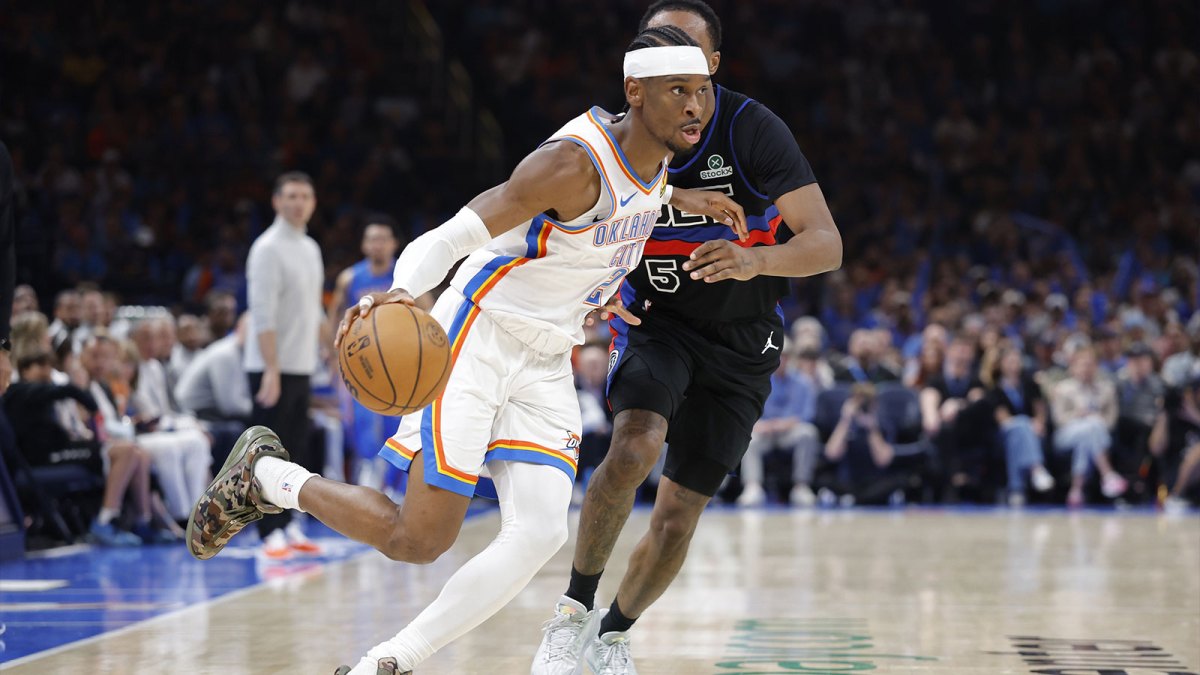 Thunder guard Shai Gilgeous-Alexander (2) drives around Detroit Pistons forward Ronald Holland II (5) during the second half at Paycom Center with Thunder coach Mark Daigneault in the background