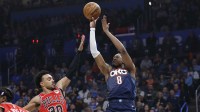 Thunder guard Jalen Williams (8) shoots as Chicago Bulls guard Tre Jones (30) defends during the first quarter at Paycom Center with Thunder head coach Mark Daigneault in the background