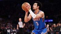 Thunder guard Jared McCain (3) shoots the ball against the New York Knicks during the first half at Madison Square Garden with Thunder head coach Mark Daigneault in the background
