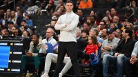 Thunder Head Coach Mark Daigneault looks on against the Washington Wizards during the first half at Capital One Arena with Thunder's Isaiah Hartenstein in the background