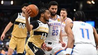 Thunder guard Ajay Mitchell (25) defends during the first half at Capital One Arena with Justin Champagnie in the background