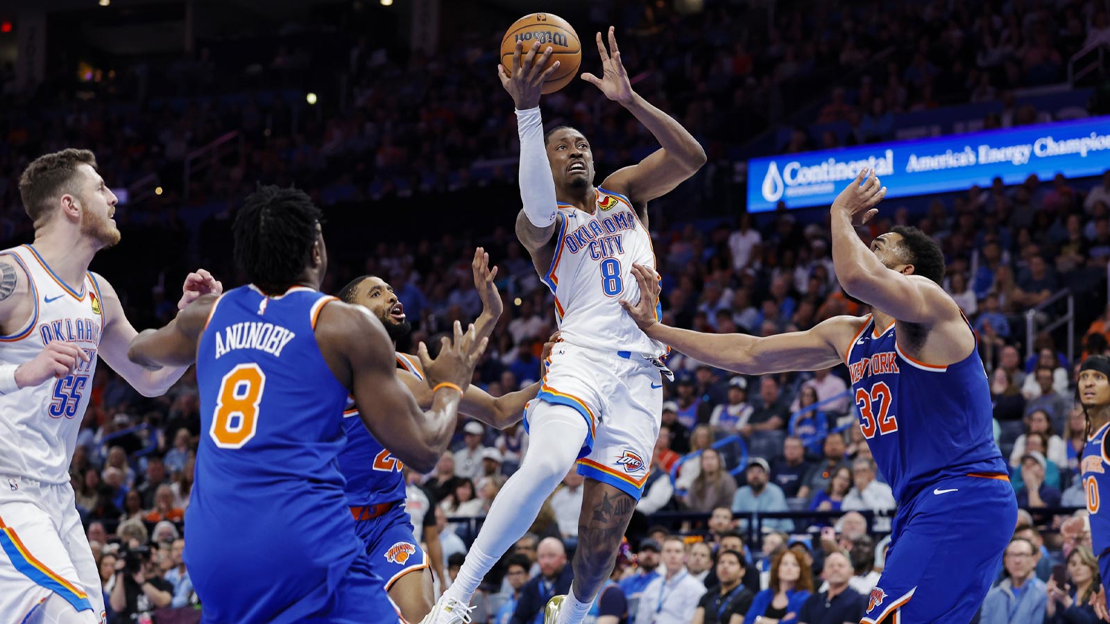 Thunder guard Jalen Williams (8) shoots between New York Knicks center Karl-Anthony Towns (32) and forward Og Anunoby (8) during the second half at Paycom Center
