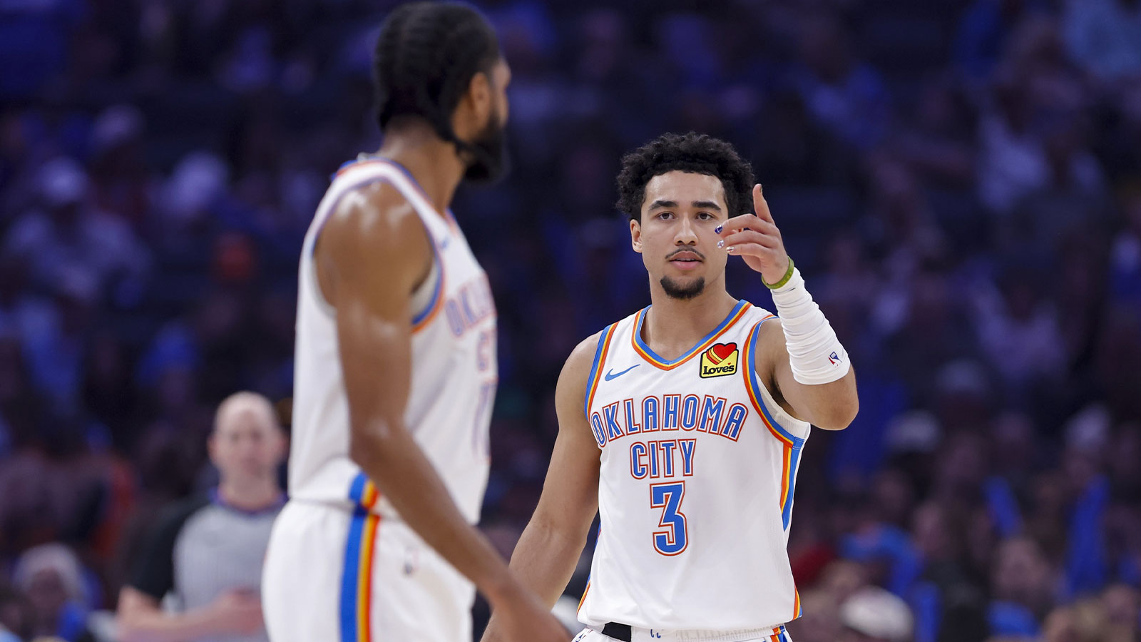 Thunder guard Jared McCain (3) talks with guard Isaiah Joe (11) before a play against the Houston Rockets during the first half at Paycom Center