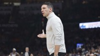 Thunder Head Coach Mark Daigneault yells to his team during a play against the Denver Nuggets during the first quarter at Paycom Center with Nuggets head coach David Adelman in the background