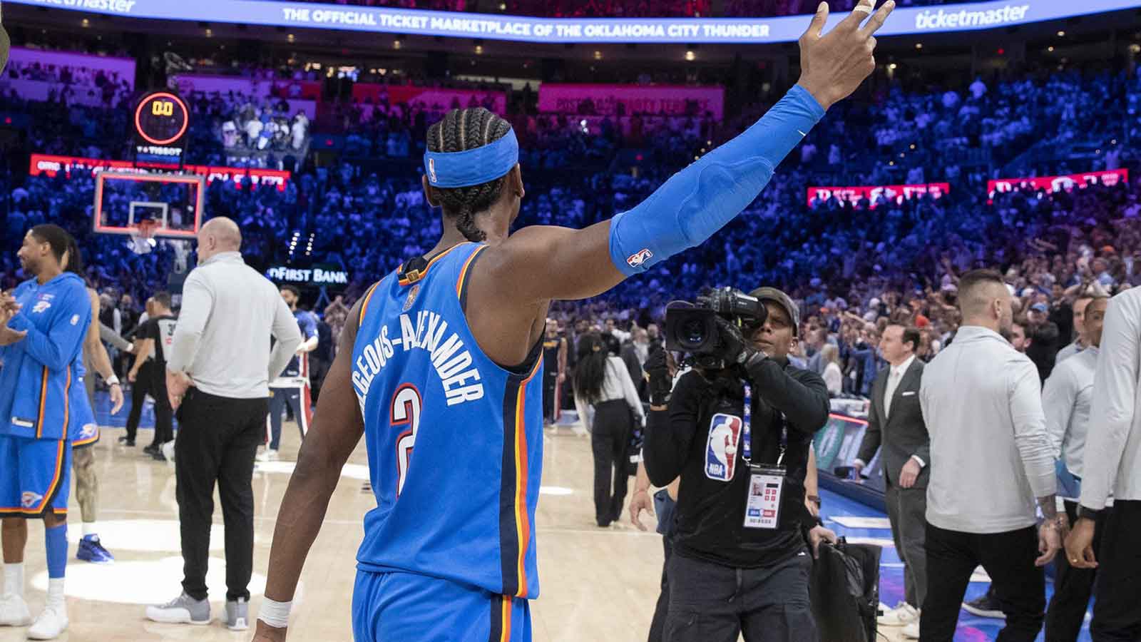 Thunder guard Shai Gilgeous-Alexander (2) gestures and walks around the court after sinking a game winner 3 pointer basket against the Denver Nuggets during the second half at Paycom Center