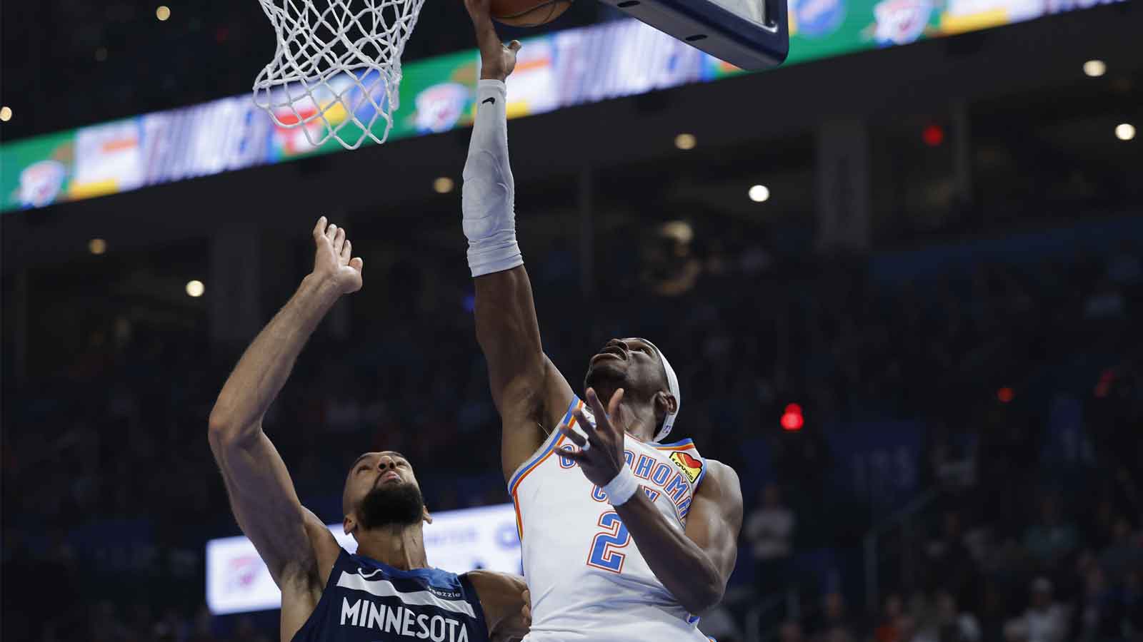 Thunder guard Shai Gilgeous-Alexander (2) goes up for a basket beside Minnesota Timberwolves center Rudy Gobert (27) during the first half at Paycom Center