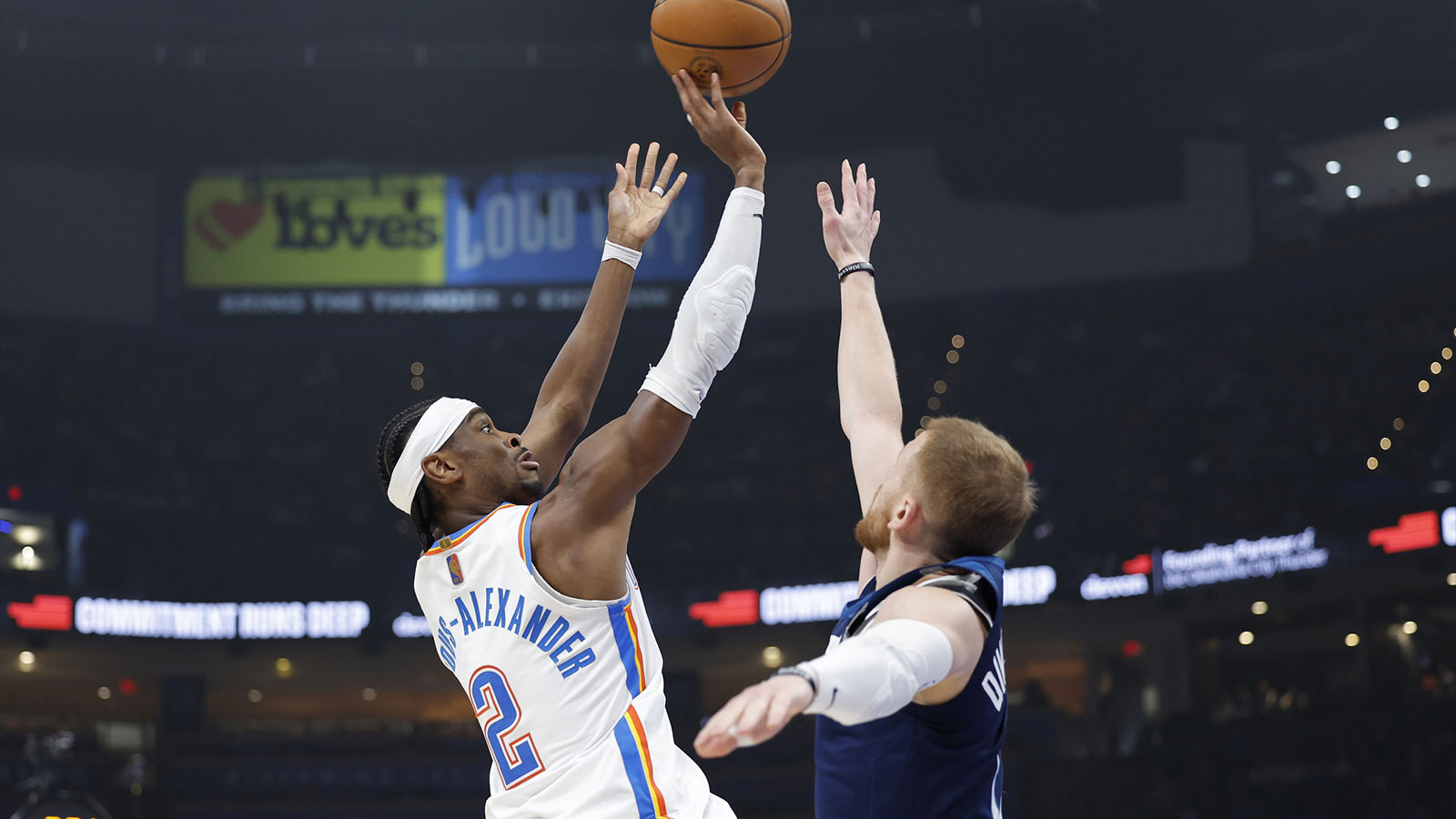 Thunder guard Shai Gilgeous-Alexander (2) shoots over Minnesota Timberwolves guard Donte DiVincenzo (0) defends the shot during the first half at Paycom Center