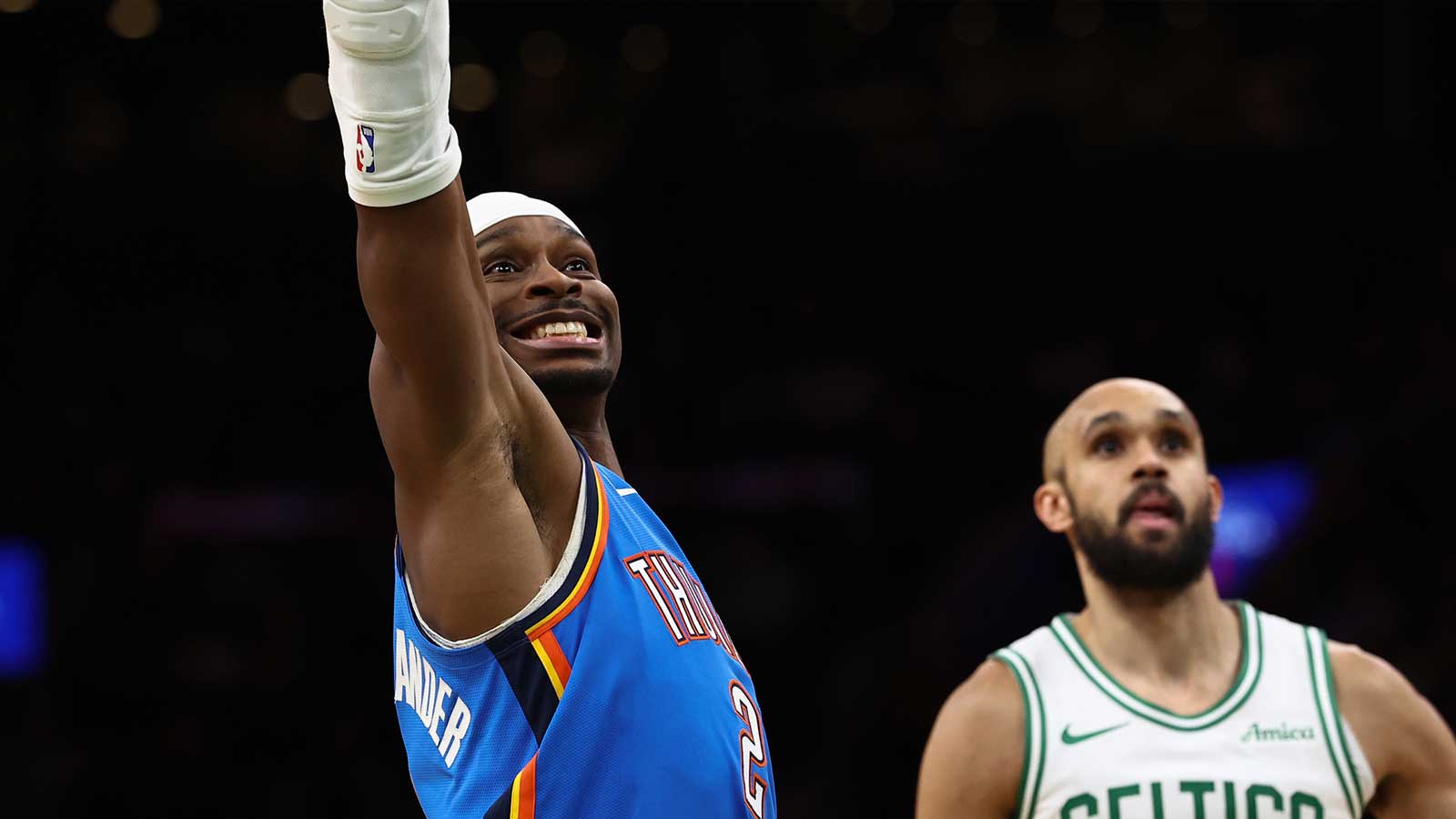 Thunder guard Shai Gilgeous-Alexander (2) grimaces as he misses a foul shot as Boston Celtics guard Derrick White (9) looks on during the fourth quarter at TD Garden