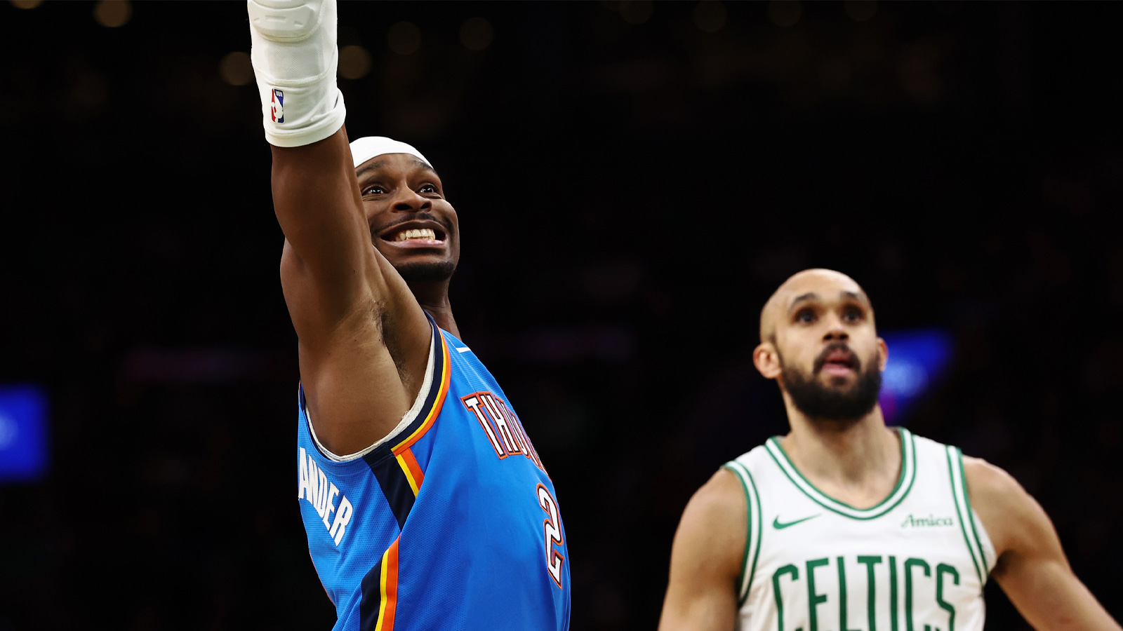 Thunder guard Shai Gilgeous-Alexander (2) grimaces as he misses a foul shot as Boston Celtics guard Derrick White (9) looks on during the fourth quarter at TD Garden