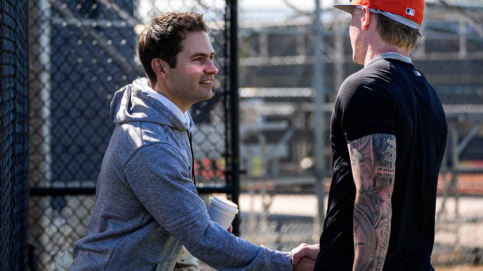 Detroit Tigers president of baseball operations Scott Harris, left, shakes hands with outfielder Max Clark at practice during spring training at TigerTown in Lakeland, Fla. on Friday, Feb. 13, 2026.