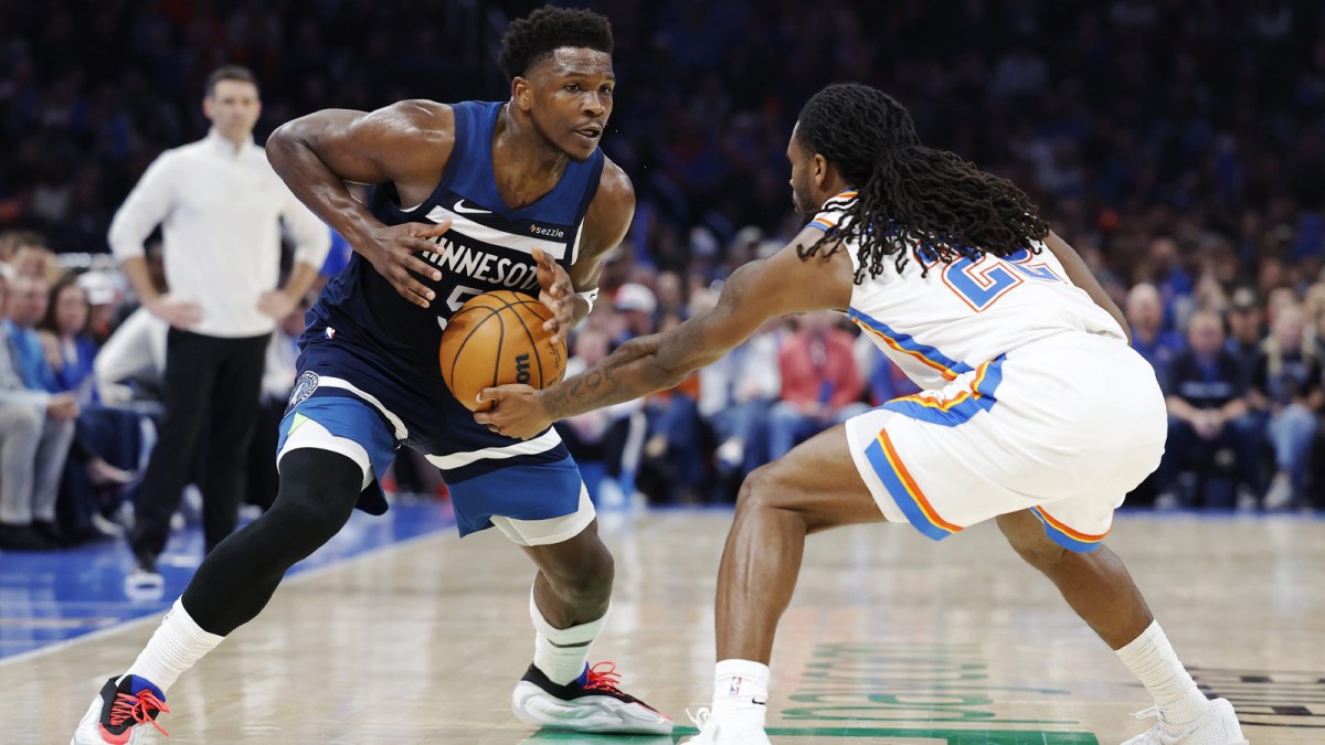 Thunder guard Cason Wallace (22) steals the ball away from Minnesota Timberwolves guard Anthony Edwards (5) during the second half at Paycom Center with Paul Pierce in the background